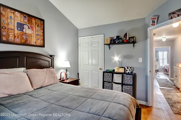 a bedroom with a bed and lamp