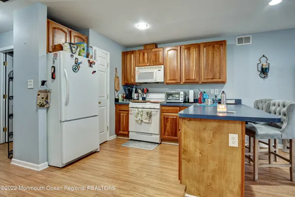 a kitchen with a refrigerator sink and cabinets