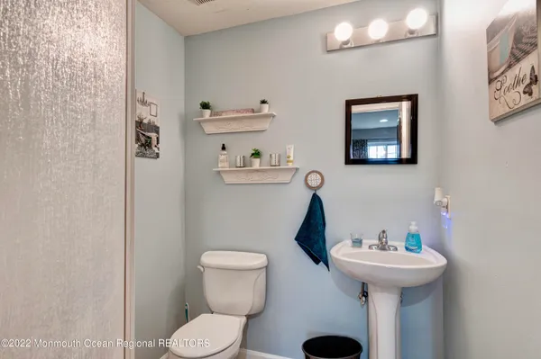 a bathroom with a toilet sink and mirror
