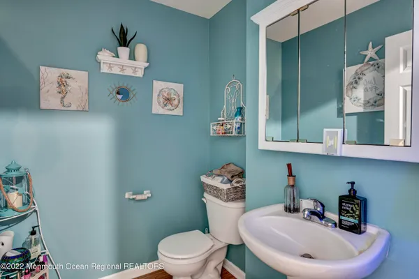 a bathroom with a toilet a sink and a mirror
