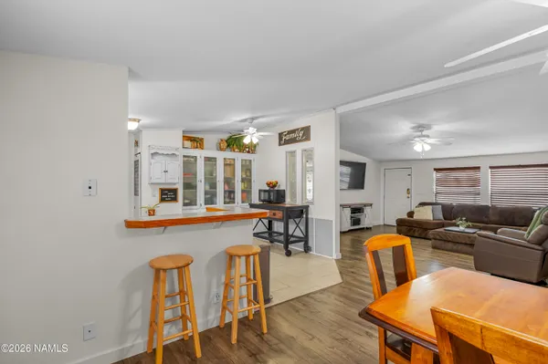 a living room with furniture wooden floor and a table