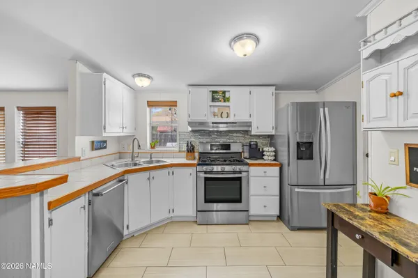 a kitchen with stainless steel appliances granite countertop a sink stove oven and refrigerator