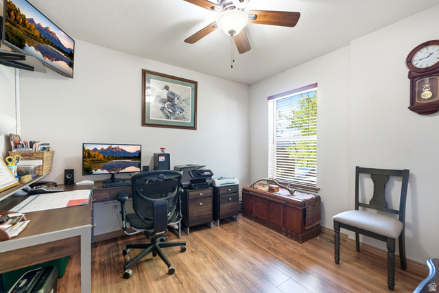 5196 Rodeo Circle Oakley, UT 84055 - Photo 19 of 57 Bedroom currently used as an office . Interior room with wood-finish flooring and a ceiling fan