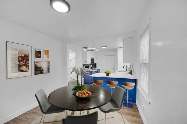 a dining room with furniture and wooden floor