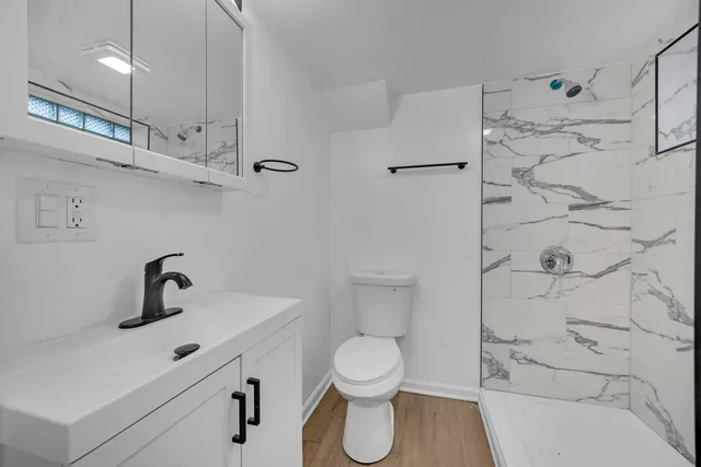 a bathroom with a toilet sink and shower