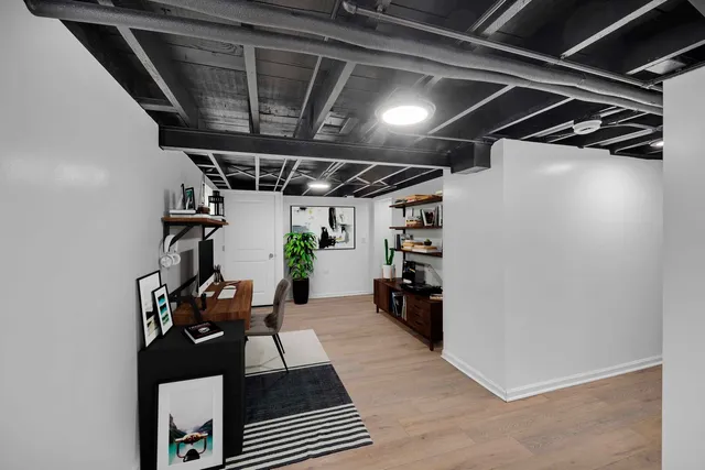 a bedroom with bed and wooden floor