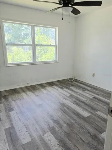 a view of room with window and ceiling fan