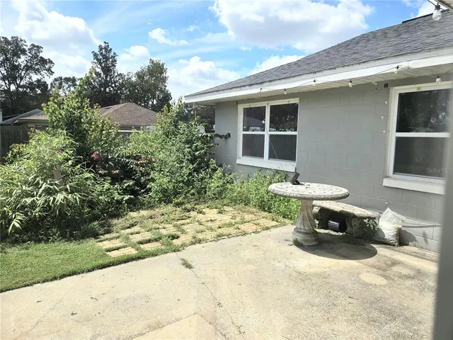 a view of a patio with table and chairs and potted plants