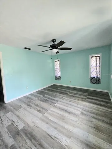 a view of a livingroom with a ceiling fan and window