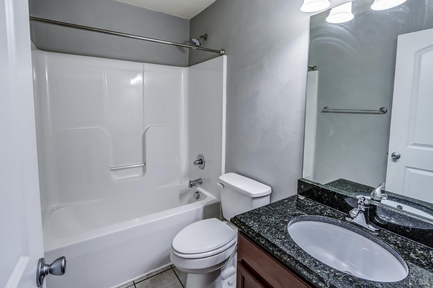 1057 Old Trail Road Forest, VA 24551 - Photo 35 of 49 a bathroom with a granite countertop sink toilet and shower