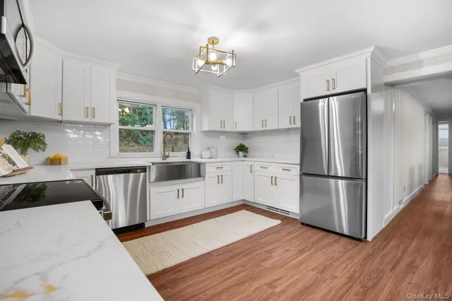 a kitchen with granite countertop a refrigerator and a sink