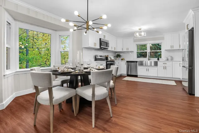 a view of a dining room with furniture window and wooden floor