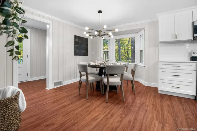 a view of a dining room with furniture window and wooden floor