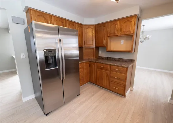 a kitchen with stainless steel appliances granite countertop a refrigerator and a sink