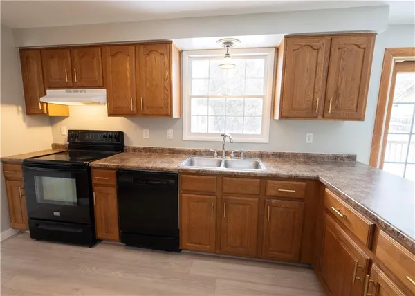 a kitchen with a sink cabinets and window