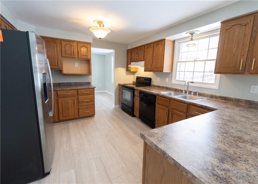 855 2nd Avenue Freedom, PA 15042 - Photo 13 of 42 a kitchen with stainless steel appliances granite countertop wooden cabinets a sink dishwasher a stove and a refrigerator with wooden floor
