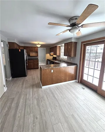 a view of a livingroom with furniture hardwood floor and a ceiling fan
