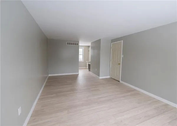 a view of an empty room and wooden floor