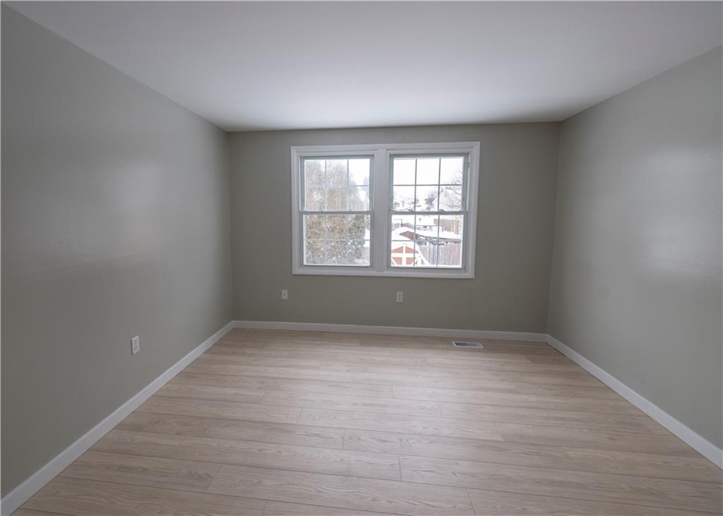 855 2nd Avenue Freedom, PA 15042 - Photo 21 of 42 an empty room with wooden floor and windows