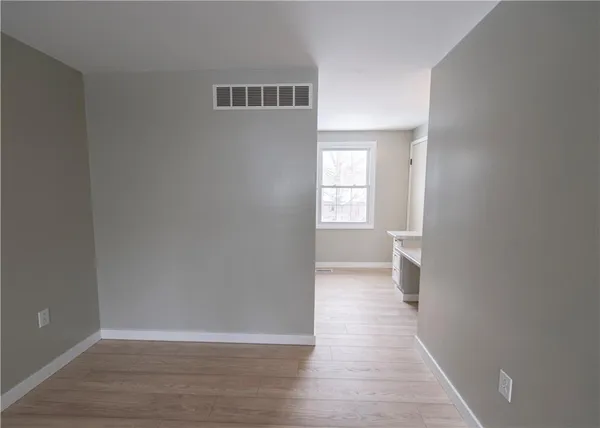 a view of a room with wooden floor and windows