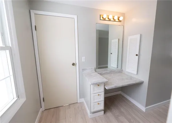 a view of a bathroom with a sink and a mirror