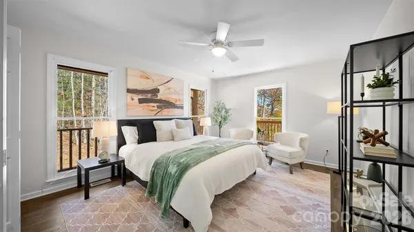 a bedroom with a bed and a large window