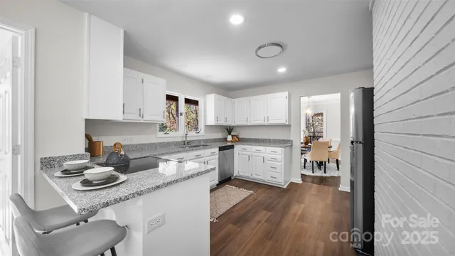 a kitchen with a sink cabinets and wooden floor