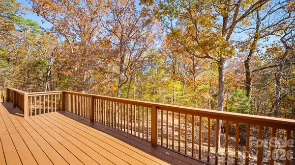a view of balcony with wooden floor and fence