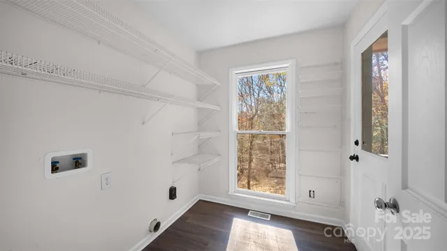 a view of room with window and hallway