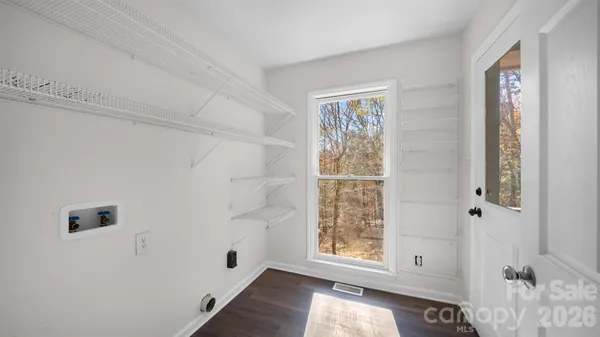 a view of room with window and hallway