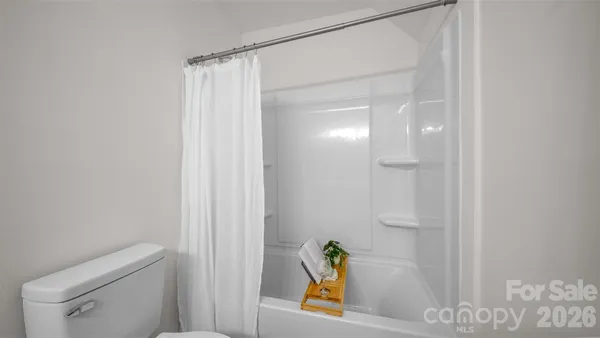 a bathroom with a shower and toilet