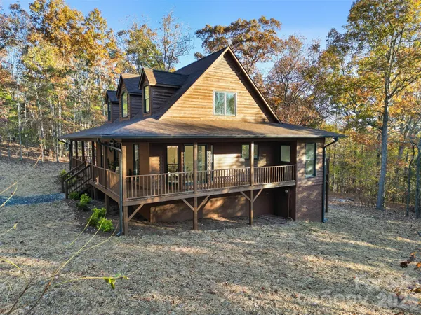 a view of a house with a yard deck and a patio