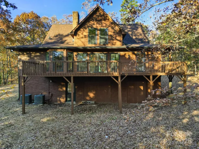 a view of a house with a yard deck and a patio