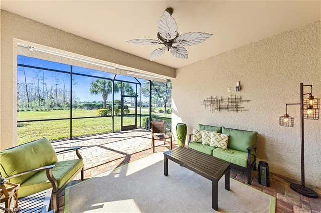 a living room with furniture and a floor to ceiling window