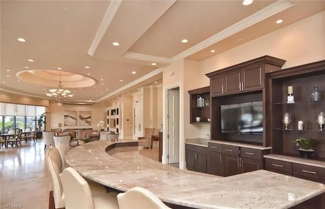 a large kitchen with stainless steel appliances kitchen island granite countertop a large counter top and stove in it