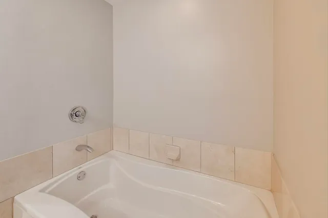 a white bath tub and a shower