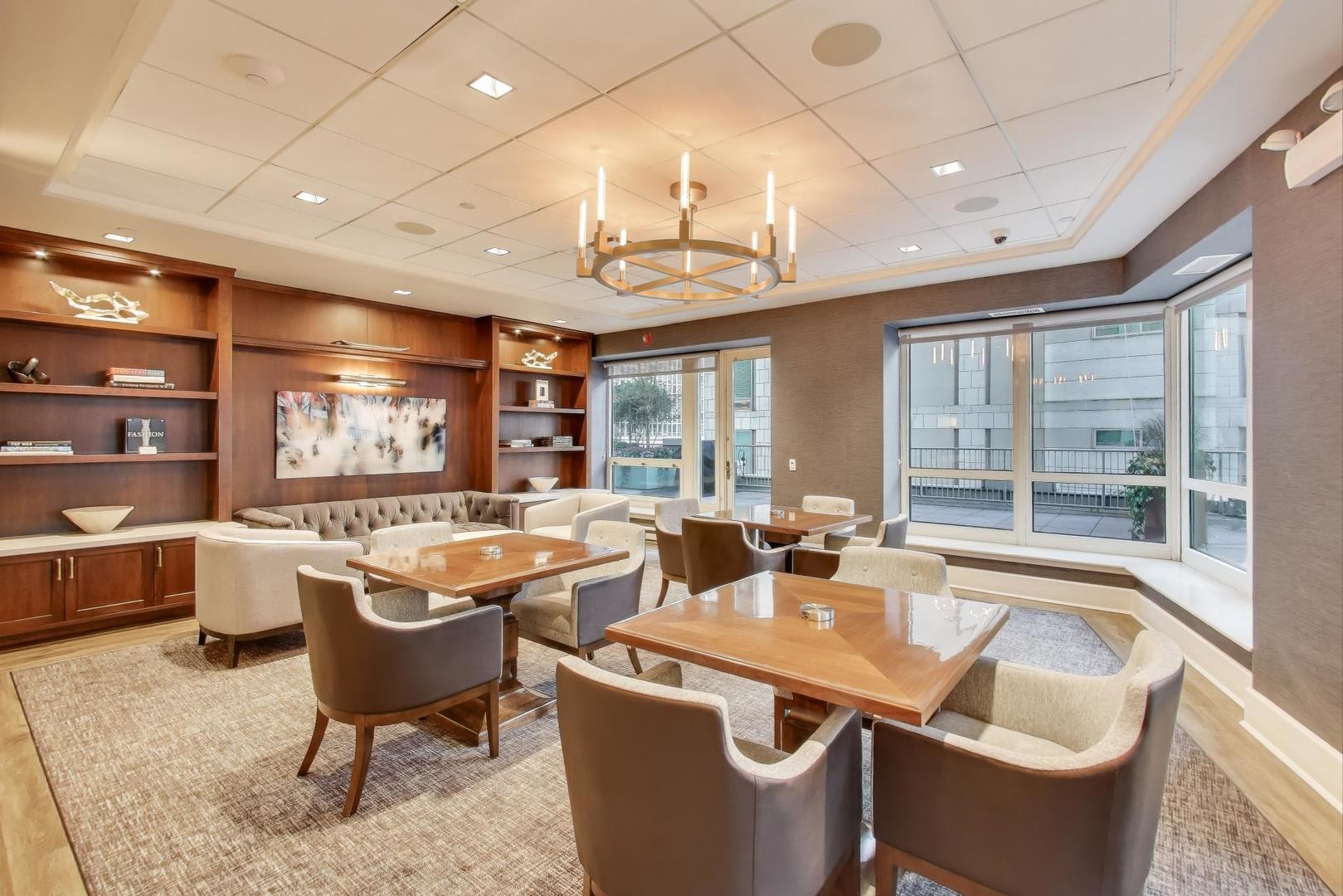 57 East Delaware Place, Unit 3504 Chicago, IL 60611 - Photo 27 of 45 a room with lots of furniture a chandelier and a large window