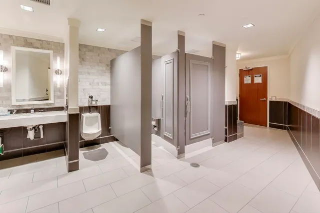 a view of kitchen with stainless steel appliances kitchen island granite countertop a refrigerator and a stove top oven