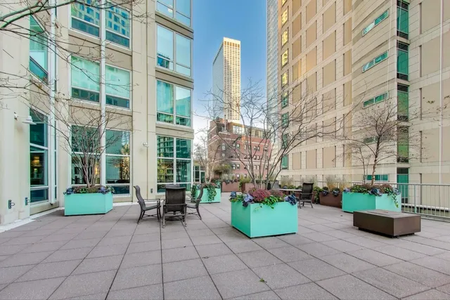 a view of a patio with couches table and chairs and potted plants