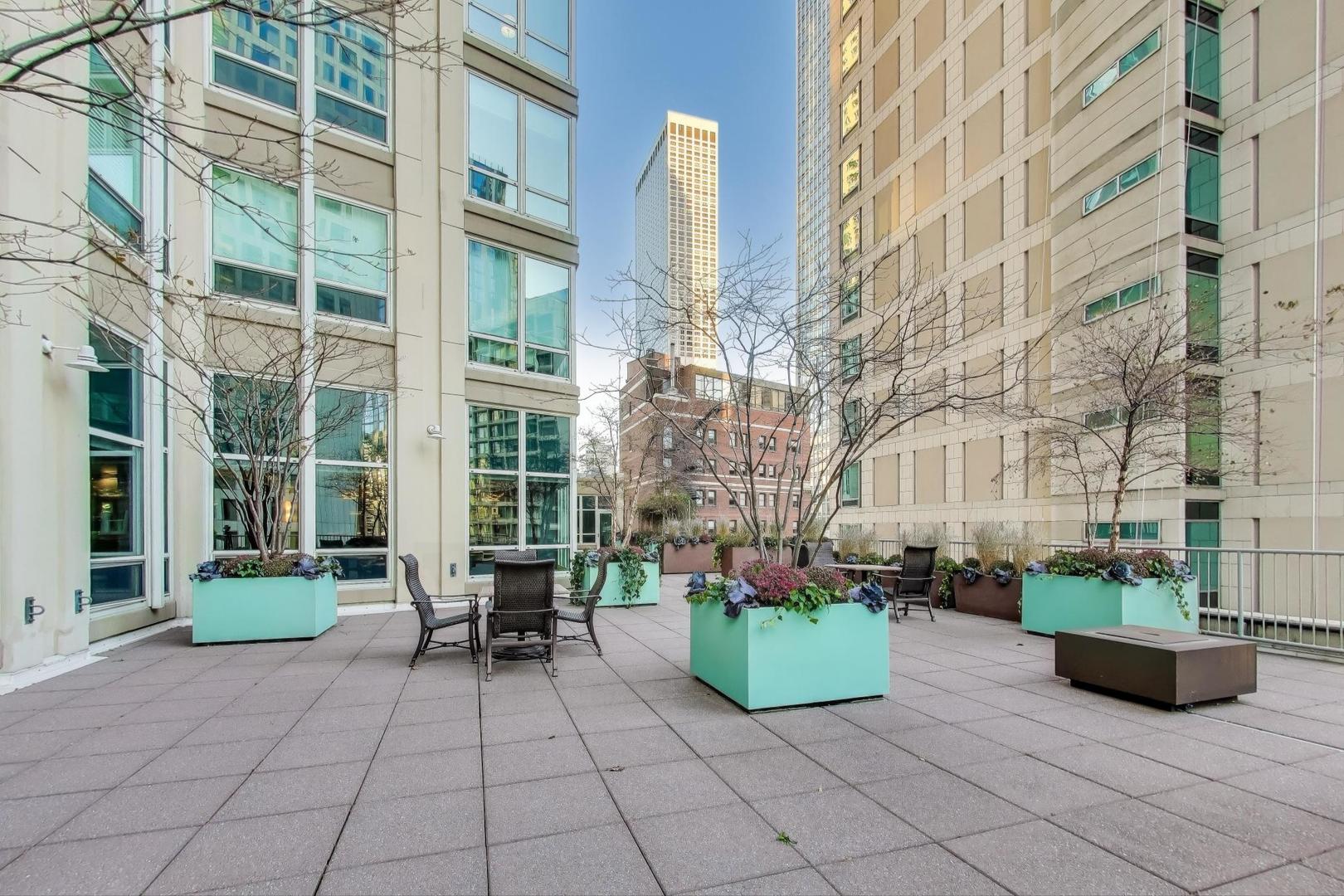 57 East Delaware Place, Unit 3504 Chicago, IL 60611 - Photo 45 of 45 a view of a patio with couches table and chairs and potted plants