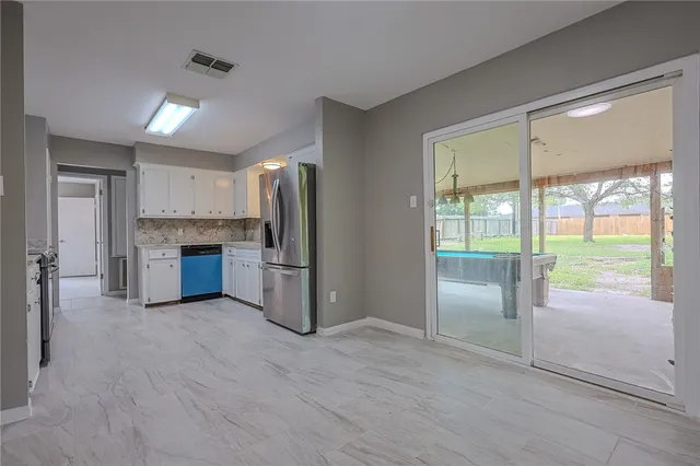 a kitchen with stainless steel appliances a refrigerator and a sink