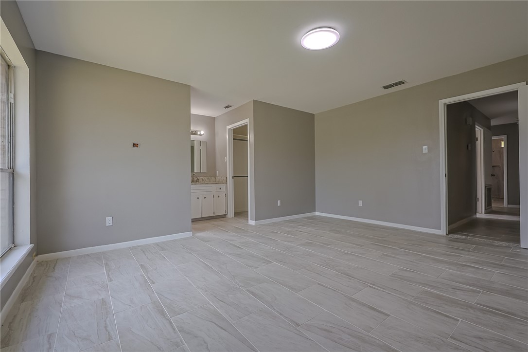 4314 Caplin Drive Corpus Christi, TX 78410 - Photo 19 of 25 a view of an empty room with wooden floor