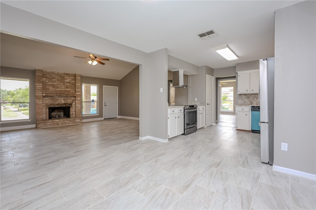 4314 Caplin Drive Corpus Christi, TX 78410 - Photo 9 of 25 a view of a kitchen and an empty room with window