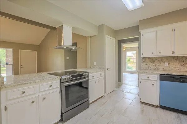 a kitchen with granite countertop a stove oven and sink