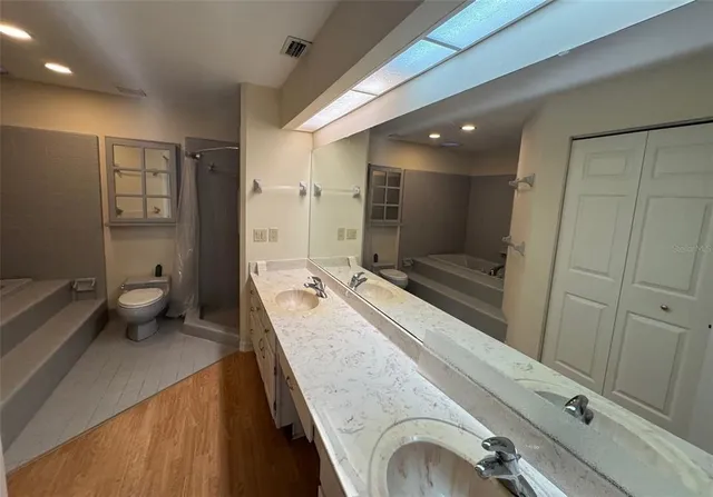a bathroom with a sink a toilet and shower
