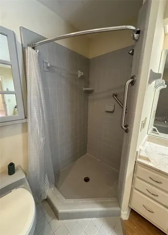 a bathroom with a shower and a toilet