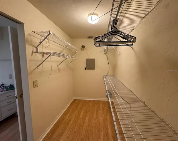 a view of a room with wooden floor