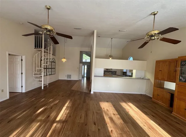 a view of a room with wooden floor