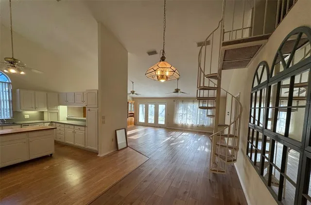 a view of a kitchen with a sink cabinets and wooden floor