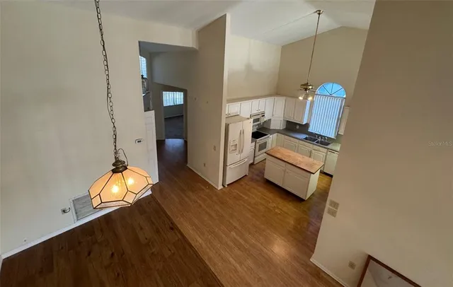 a view of a room with wooden floor